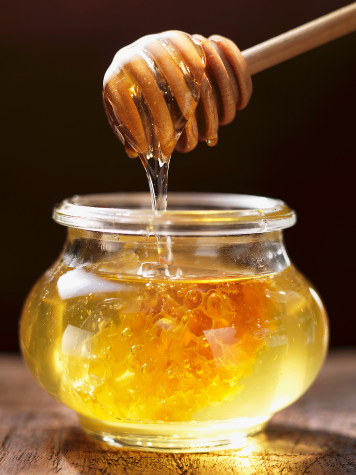 Honey Dripping from Honey Spoon